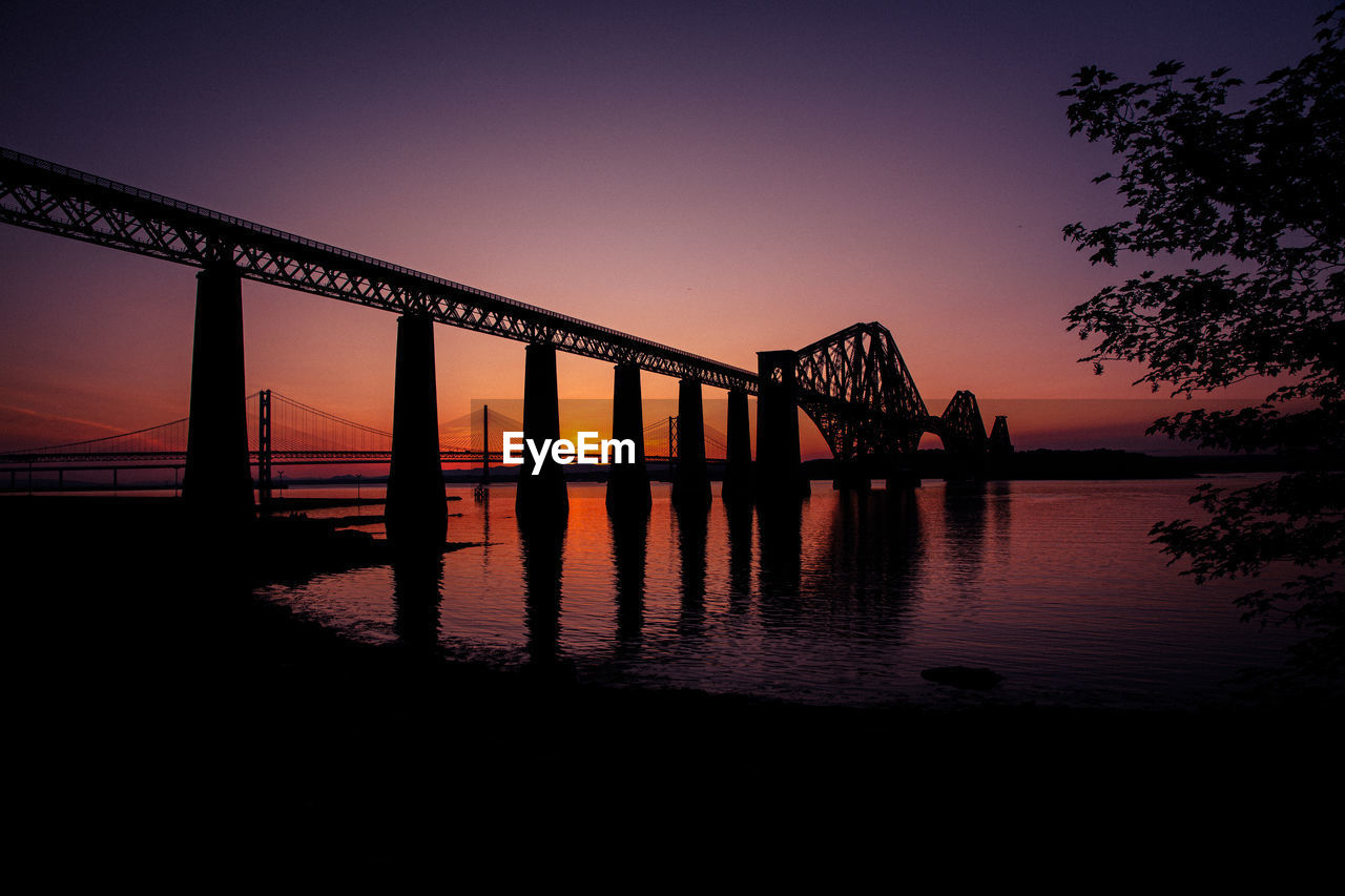 water, sky, architecture, bridge, dusk, built structure, sunset, evening, reflection, nature, silhouette, transportation, night, sea, travel destinations, beauty in nature, no people, outdoors, scenics - nature, twilight, horizon, beam bridge, tranquility, city, darkness, travel, beach, tranquil scene