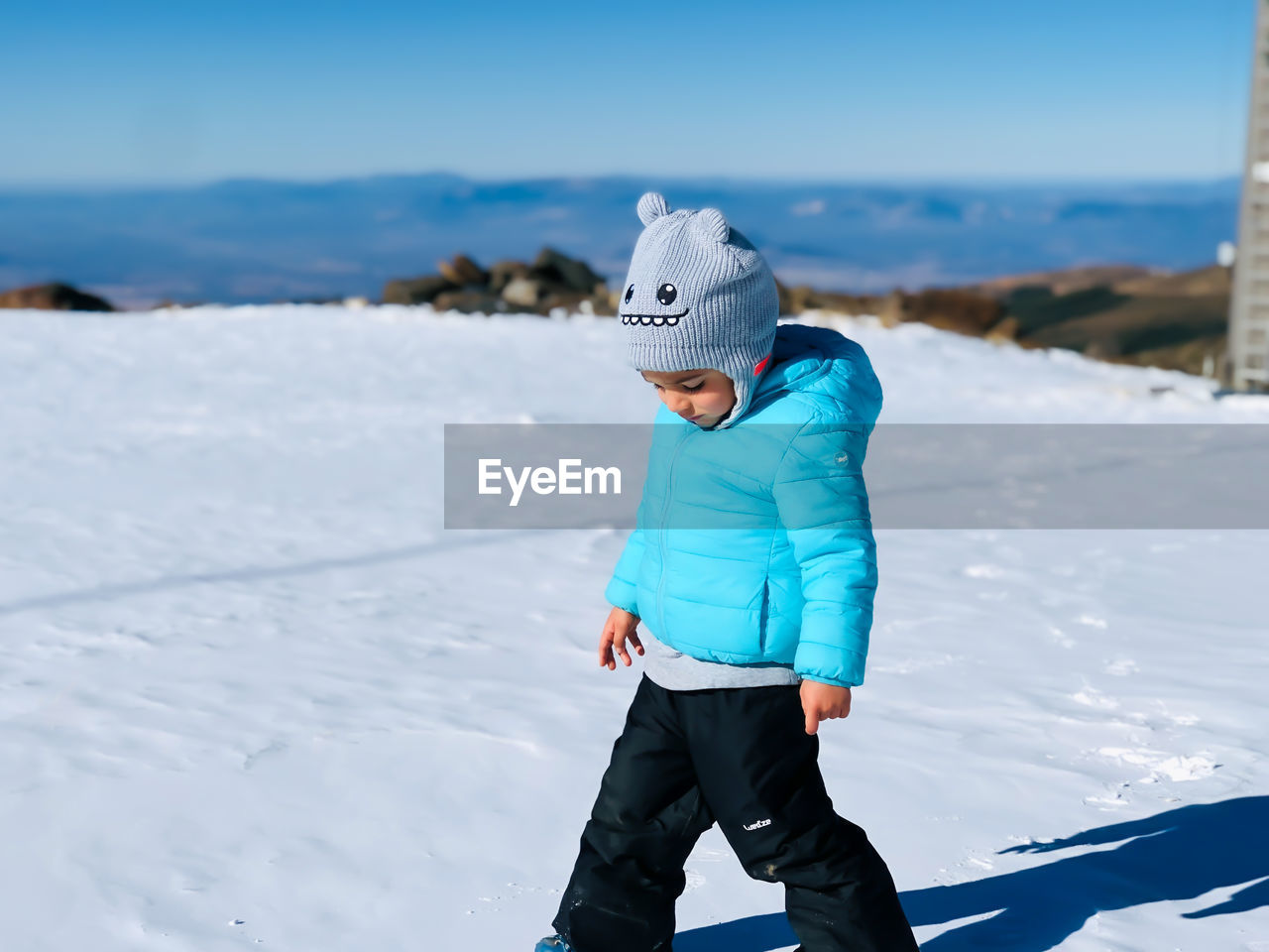 Little boy in the snow of the mountains of sierra nevada