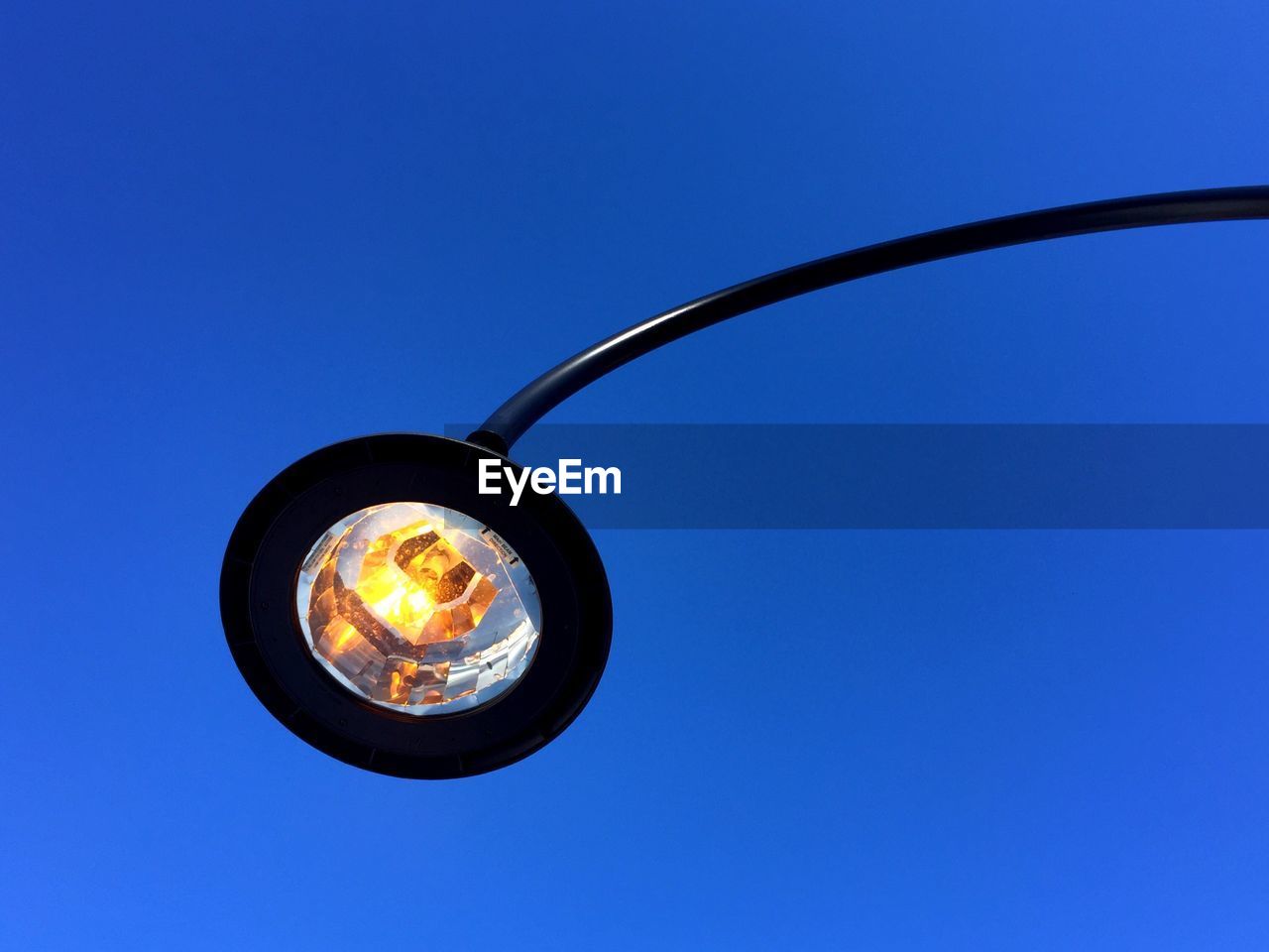 Low angle view of street light against clear blue sky at dusk