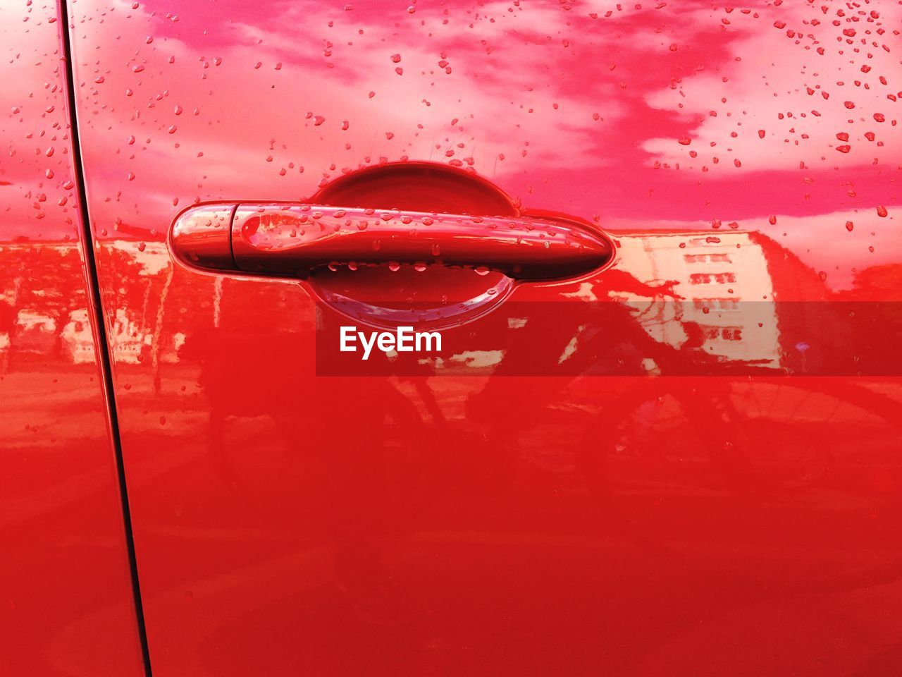 Close-up of wet red car door