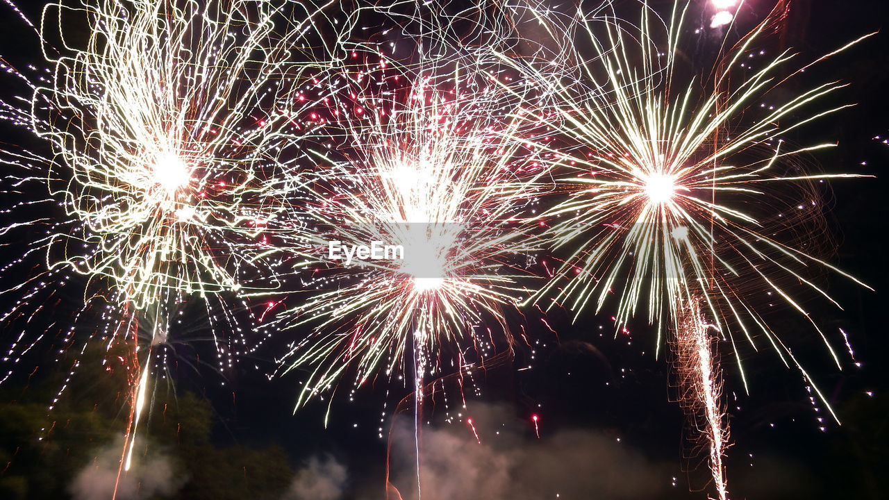 LOW ANGLE VIEW OF FIREWORK DISPLAY IN SKY AT NIGHT