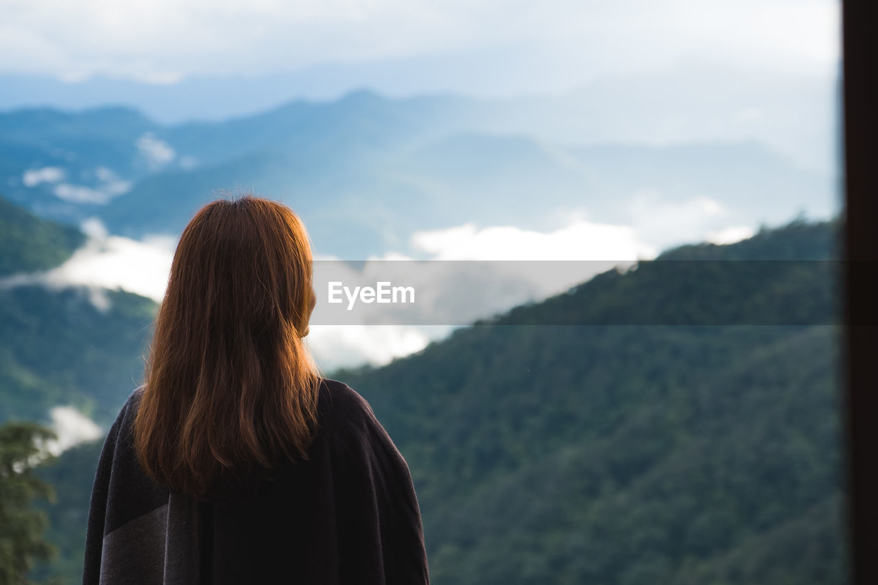 Rear view of woman looking at mountains