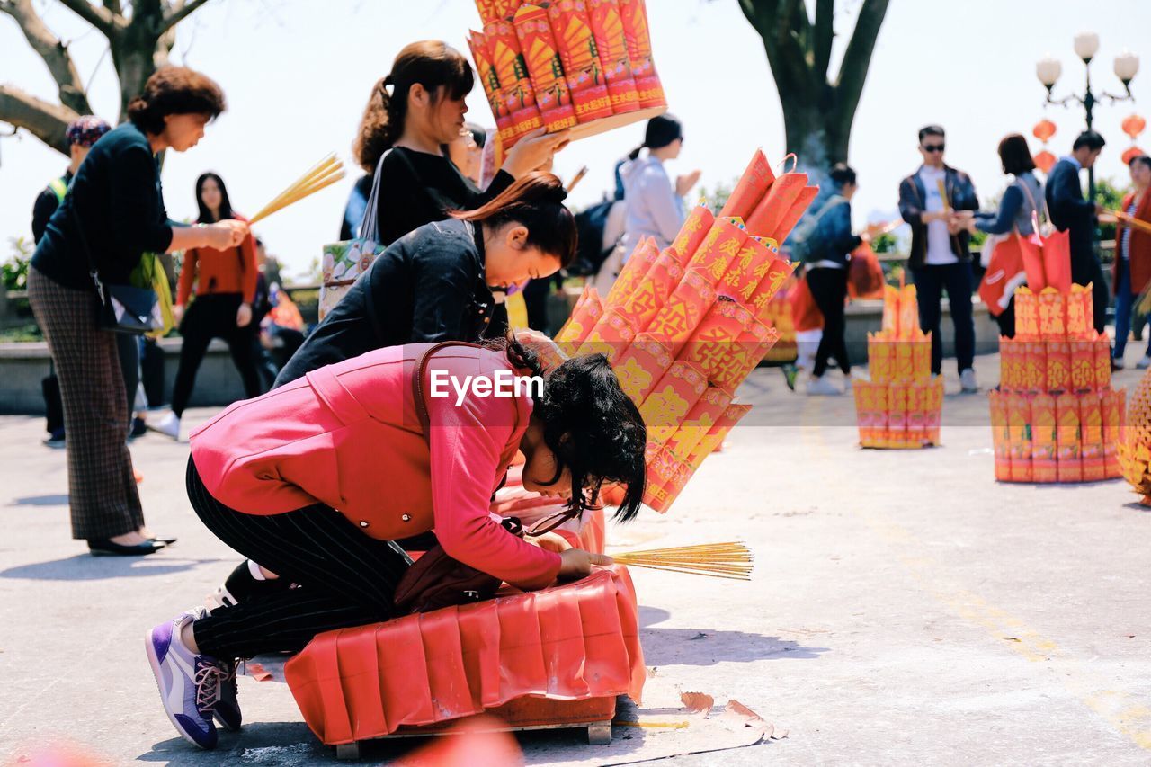 Side view of women praying at temple