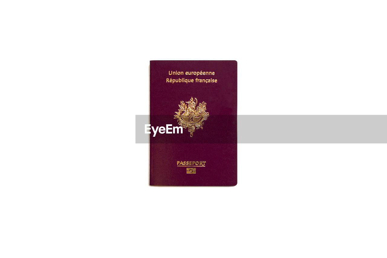 Close-up of passport over white background