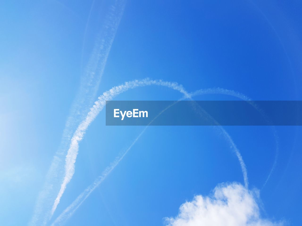 Low angle view of vapor trail against blue sky