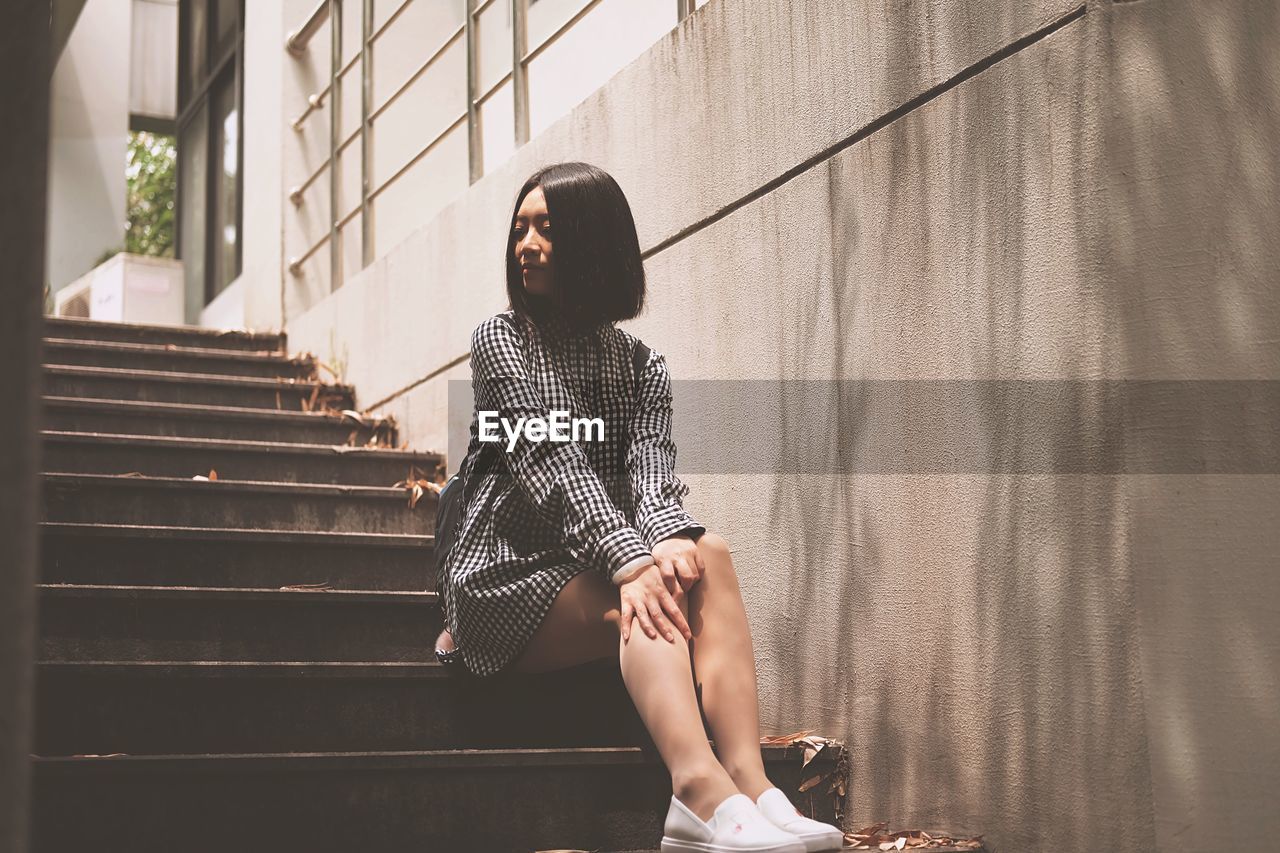 Young woman sitting on steps