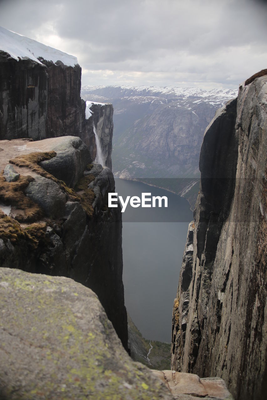 Scenic view of waterfall against sky