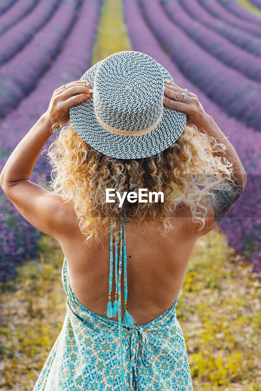 rear view of young woman wearing hat