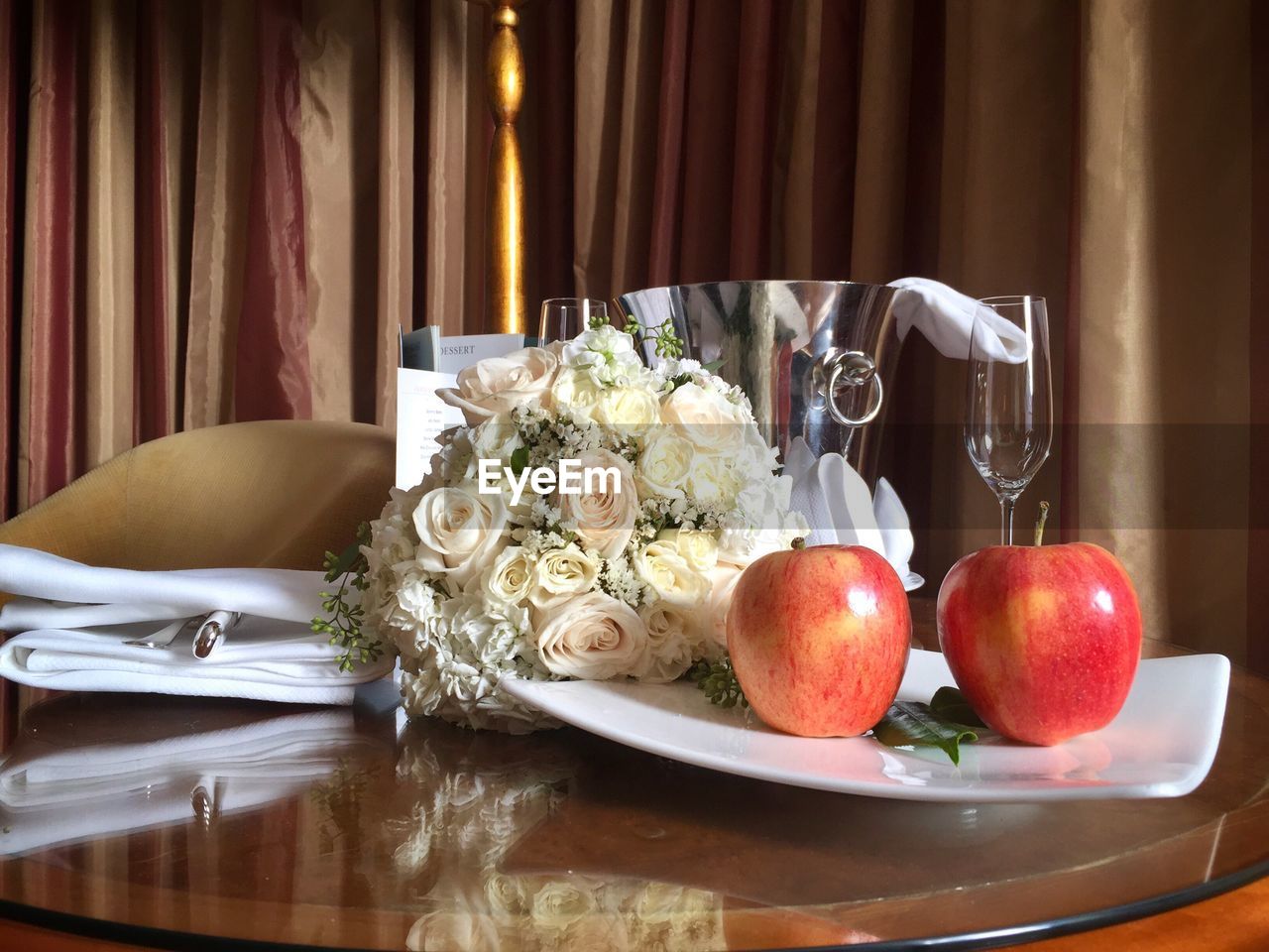 Close-up of apples and bouquet on table at restaurant