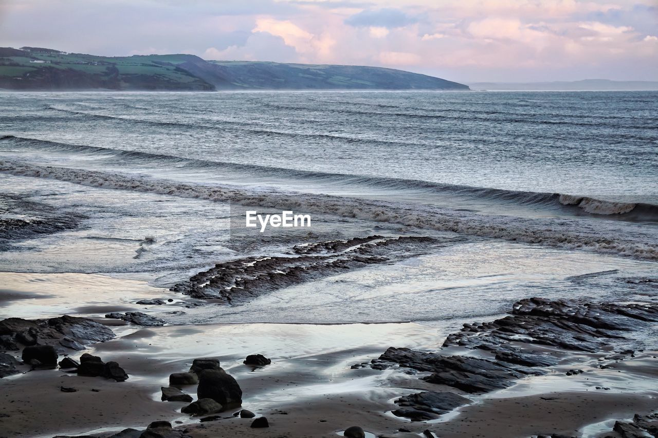 Scenic view of sea against sky at sunset