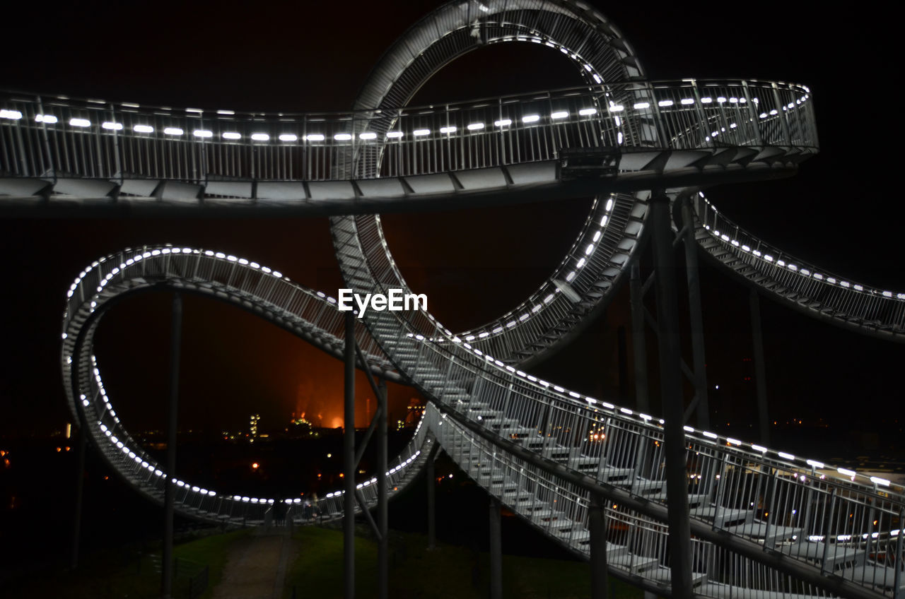 Illuminated tiger and turtle magic mountain at night