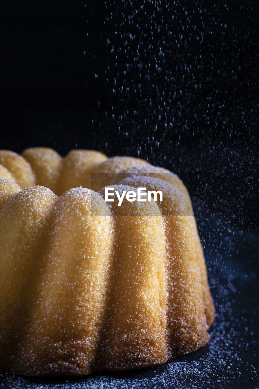 CLOSE-UP OF CAKE IN BLACK BACKGROUND