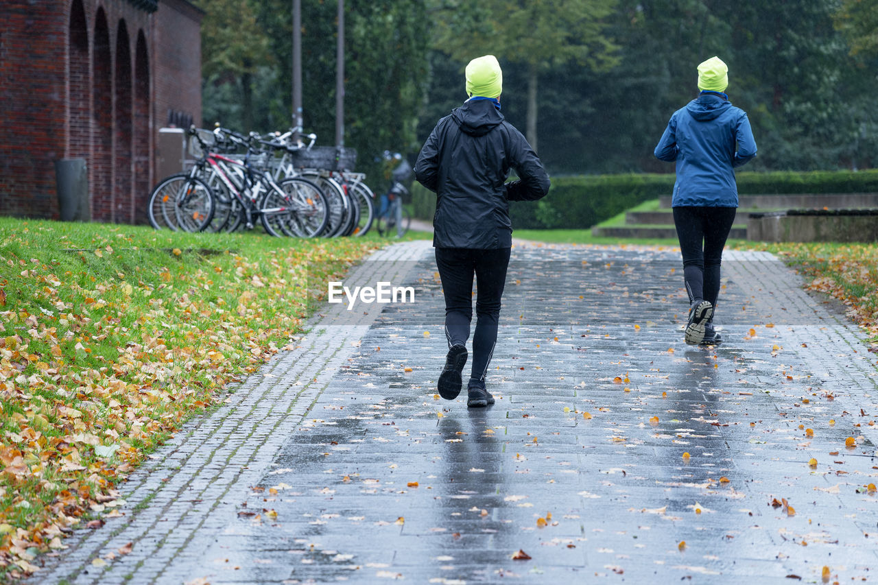 rear view of man walking on footpath