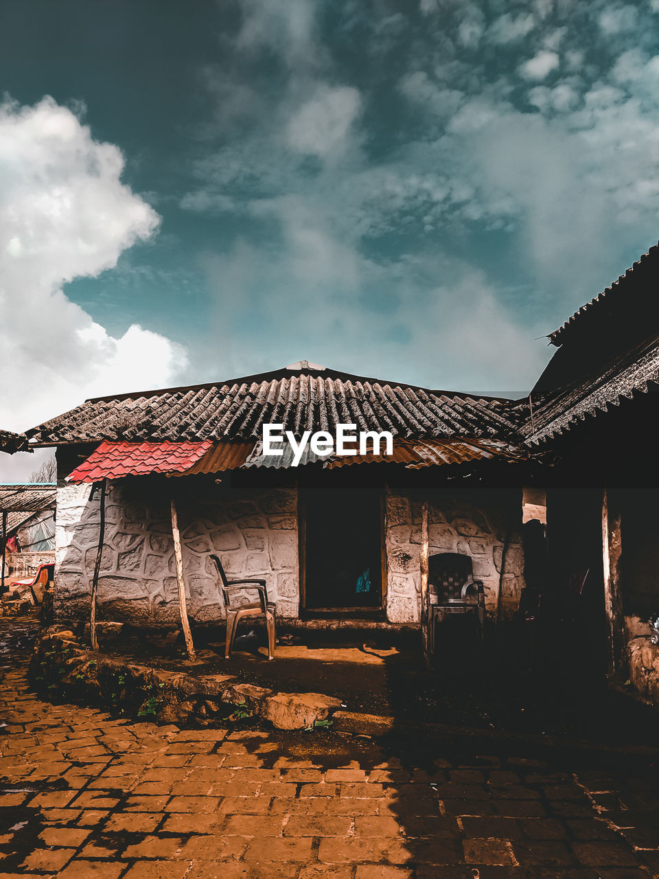 Old house against cloudy sky