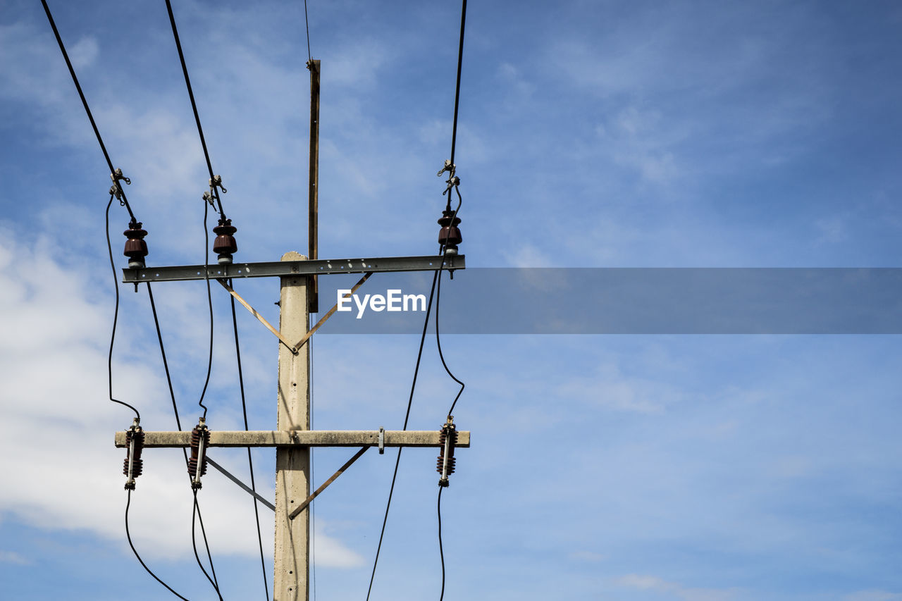 Top part of low voltage electric pole in sunny day