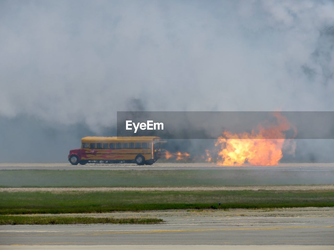 Jet engine school bus with flame and smoke on road