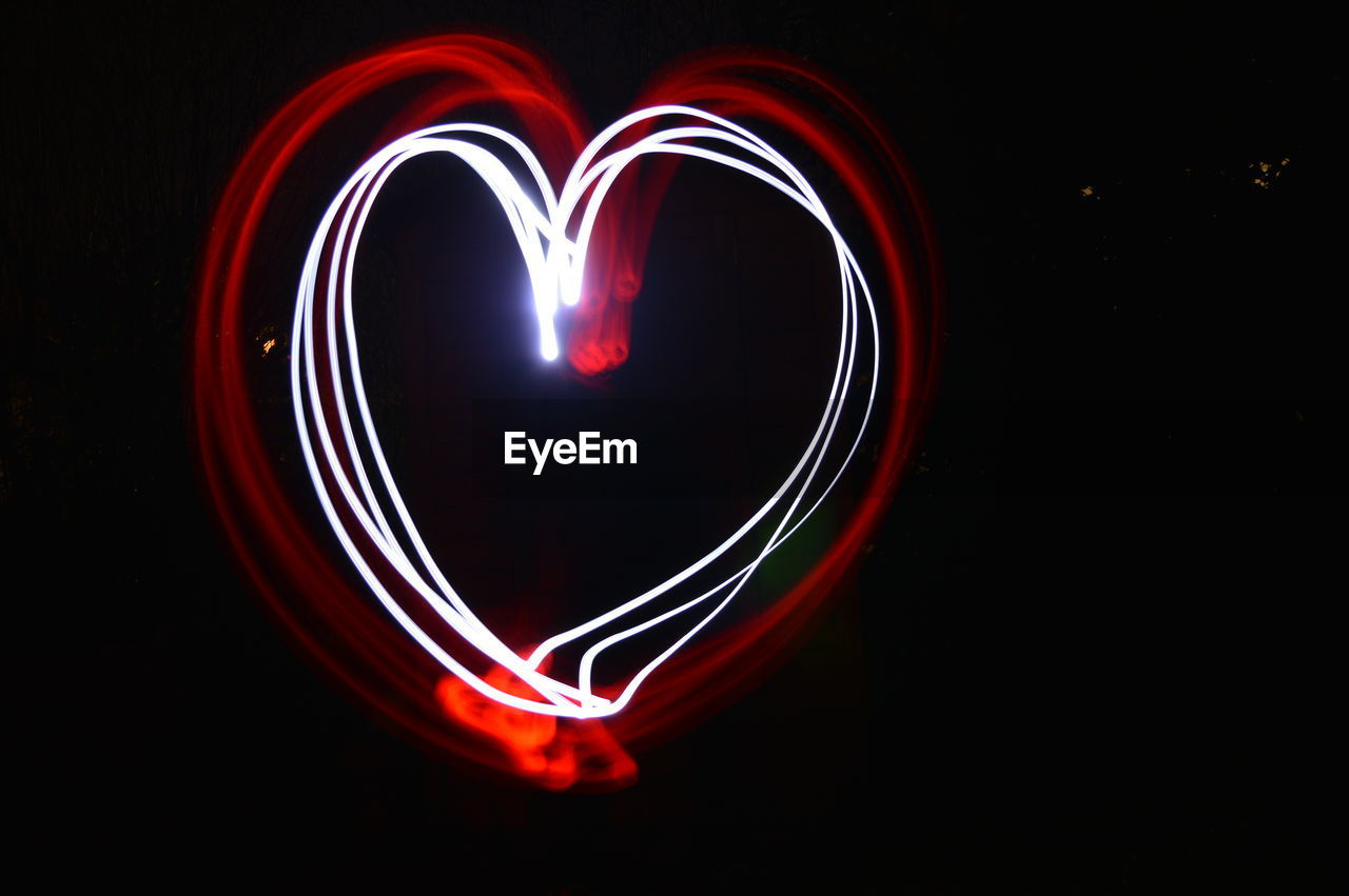 Close-up of light trails over black background