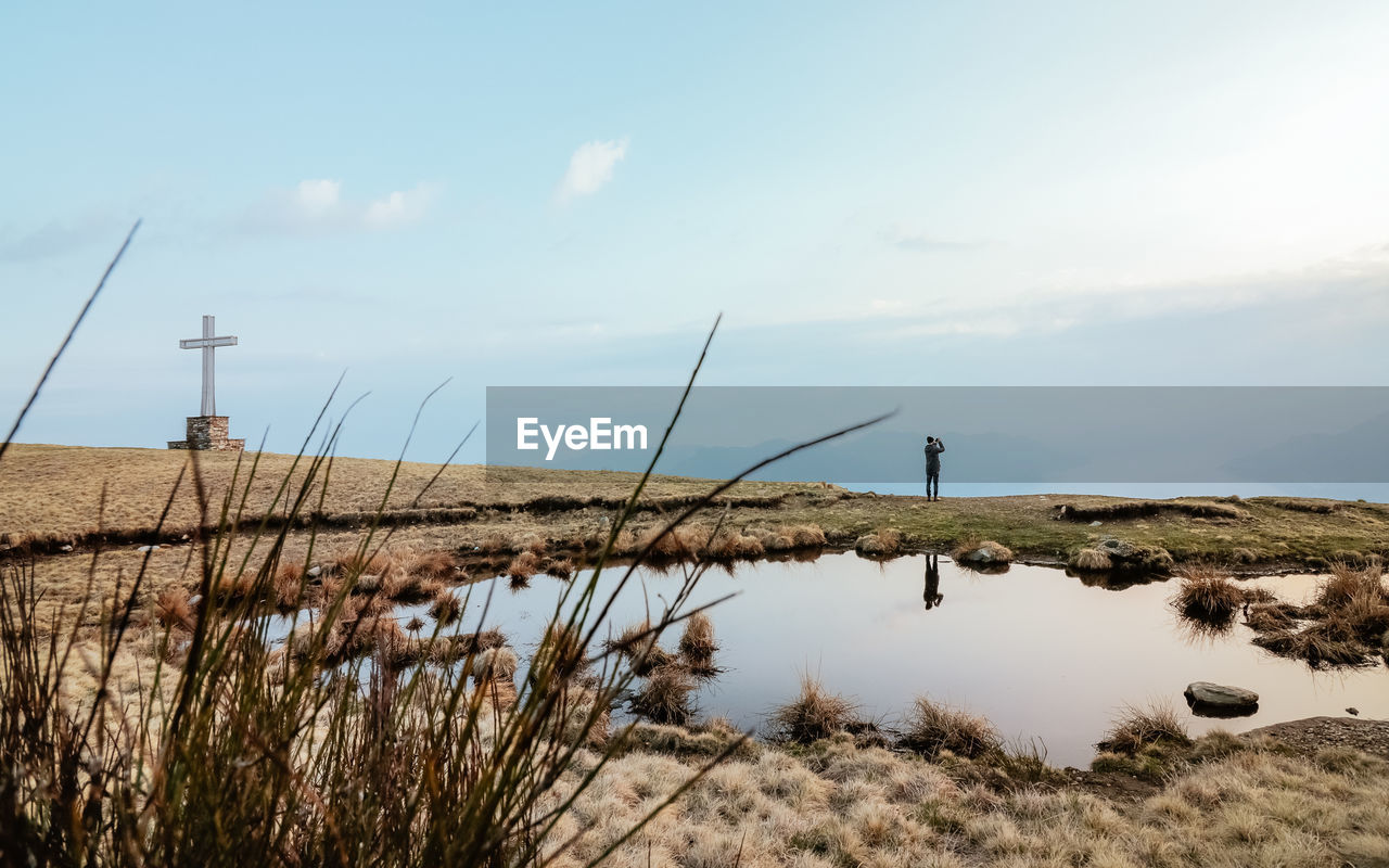 Scenic view of lake against cloudy sky