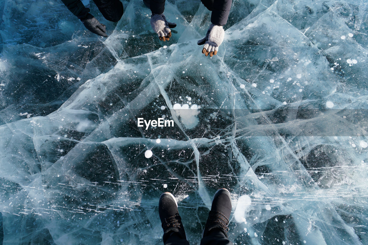 Low section of man standing on ice