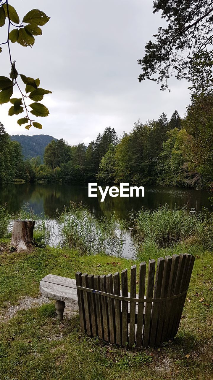 LAKE BY TREES AGAINST SKY