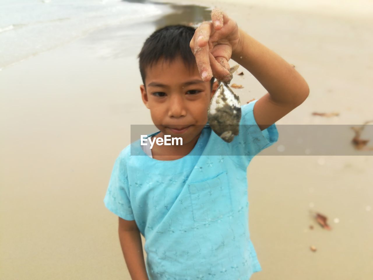 PORTRAIT OF CUTE BOY ON SHORE