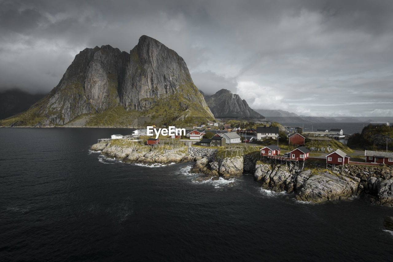 Scenic view of sea and mountains against sky