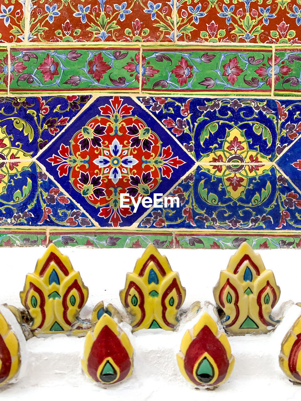 Close-up of multi colored thai pattern on tiled wall