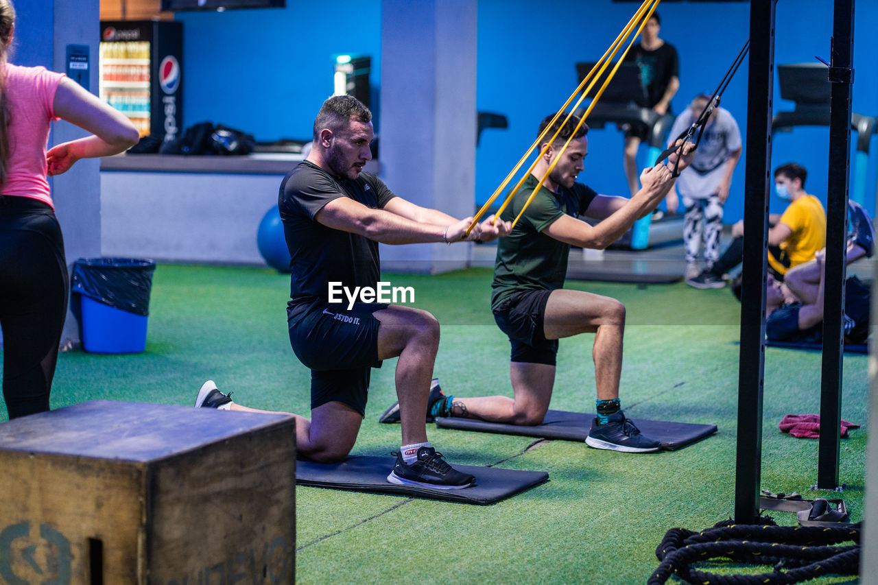 Low section of people exercising in gym