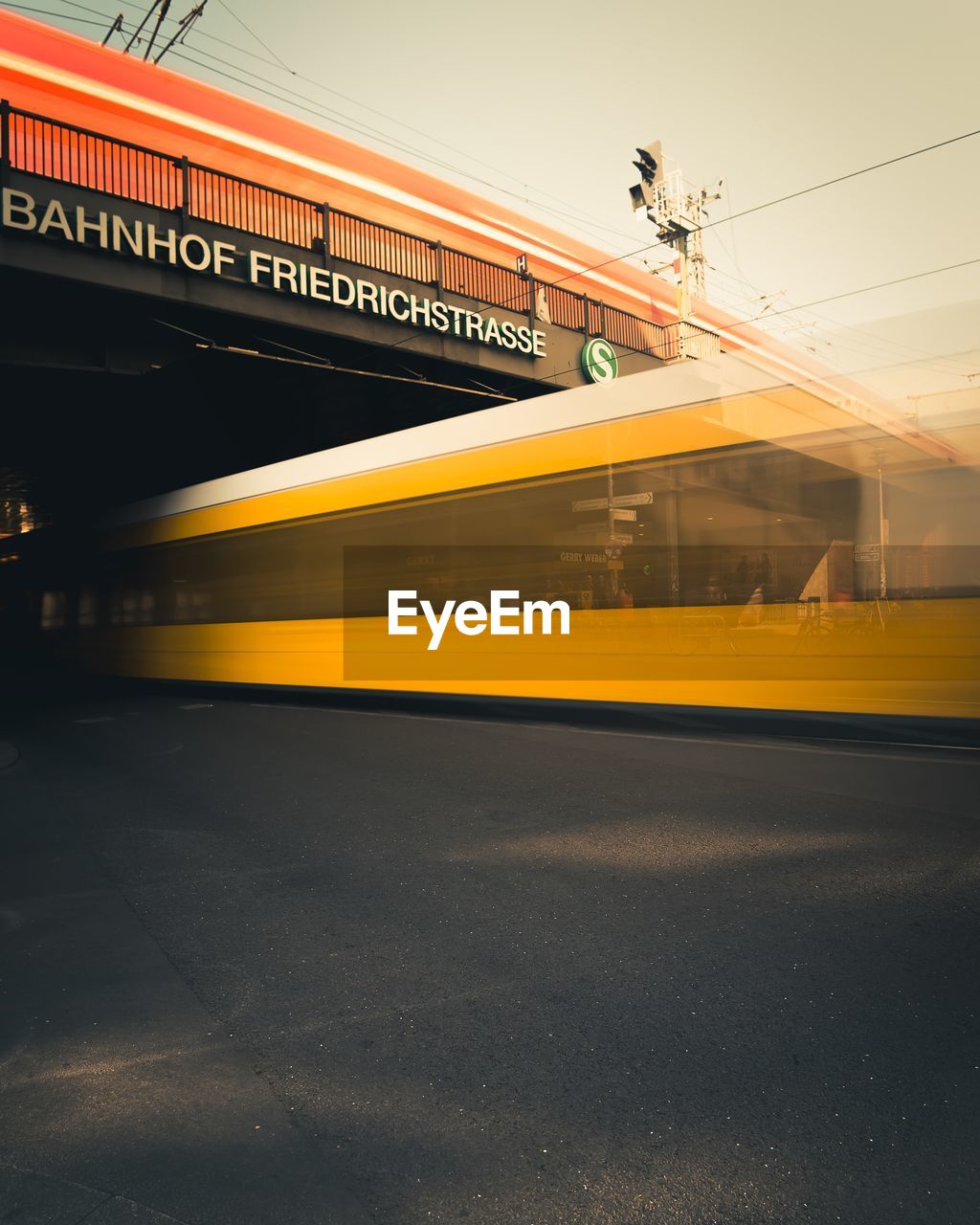Blurred motion of yellow train against sky