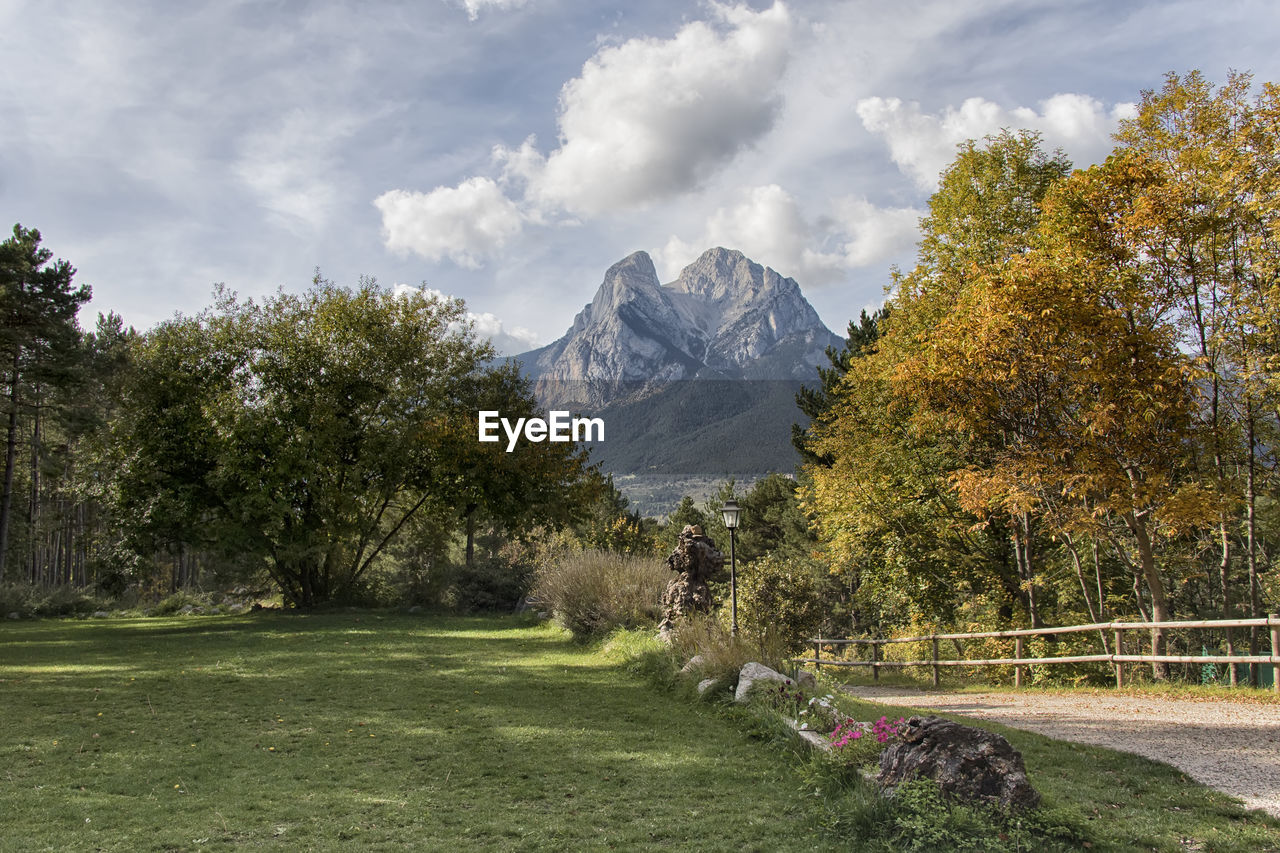 SCENIC VIEW OF MOUNTAINS AGAINST CLOUDY SKY