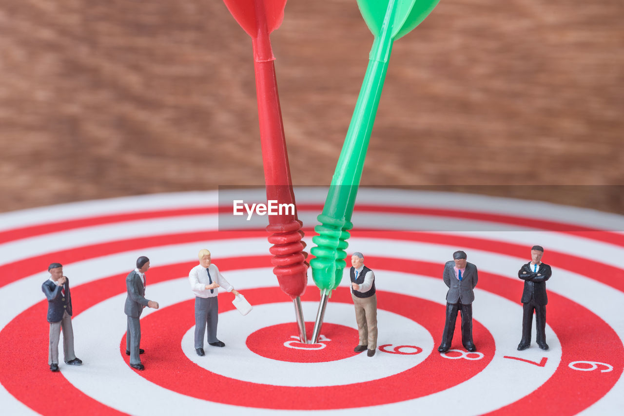 Close-up of figurines on dartboard