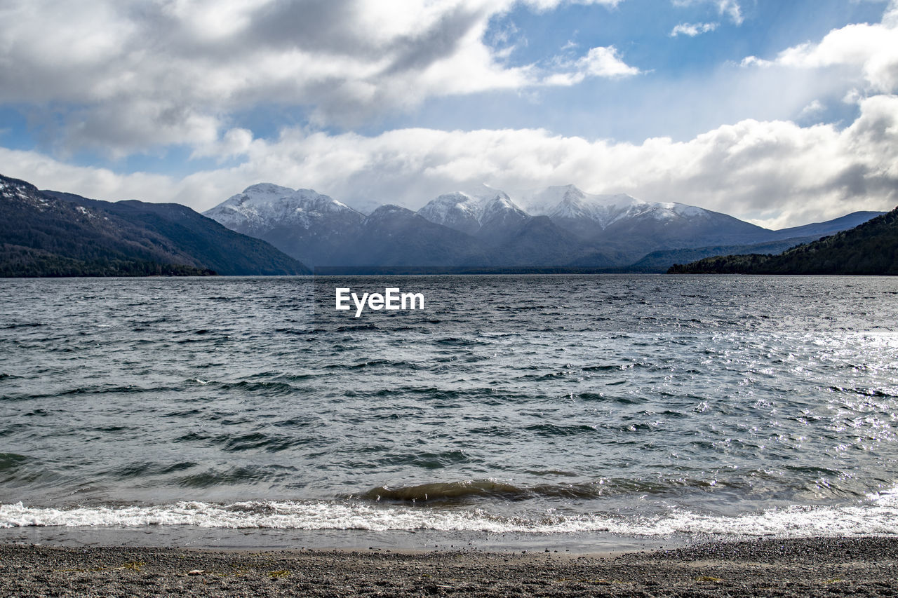 Scenic view of lake and mountains against sky