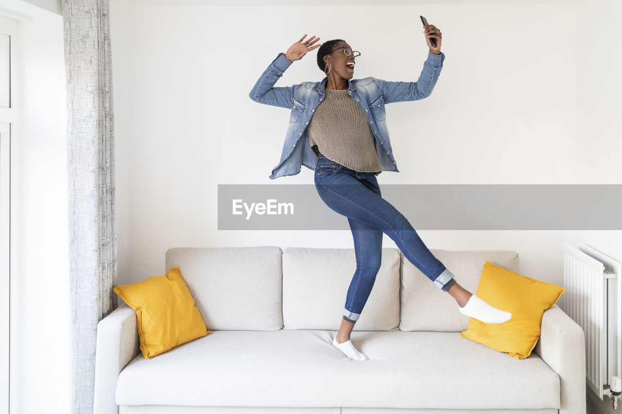 Woman dancing on sofa