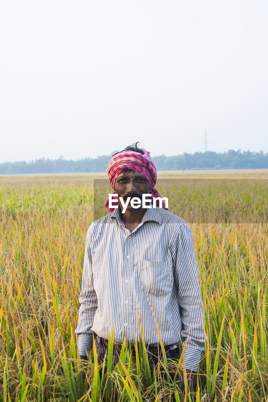 MAN STANDING IN FIELD