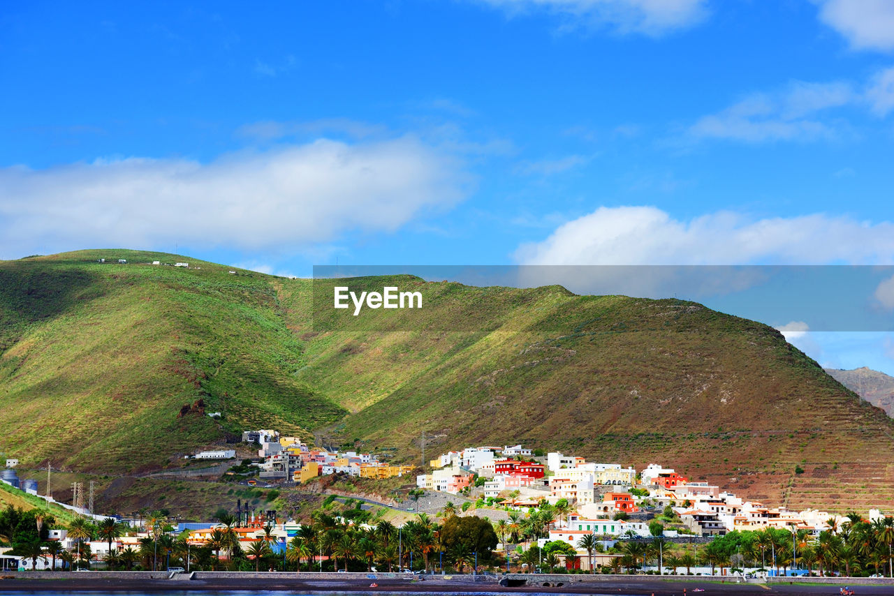 Buildings against mountain in town