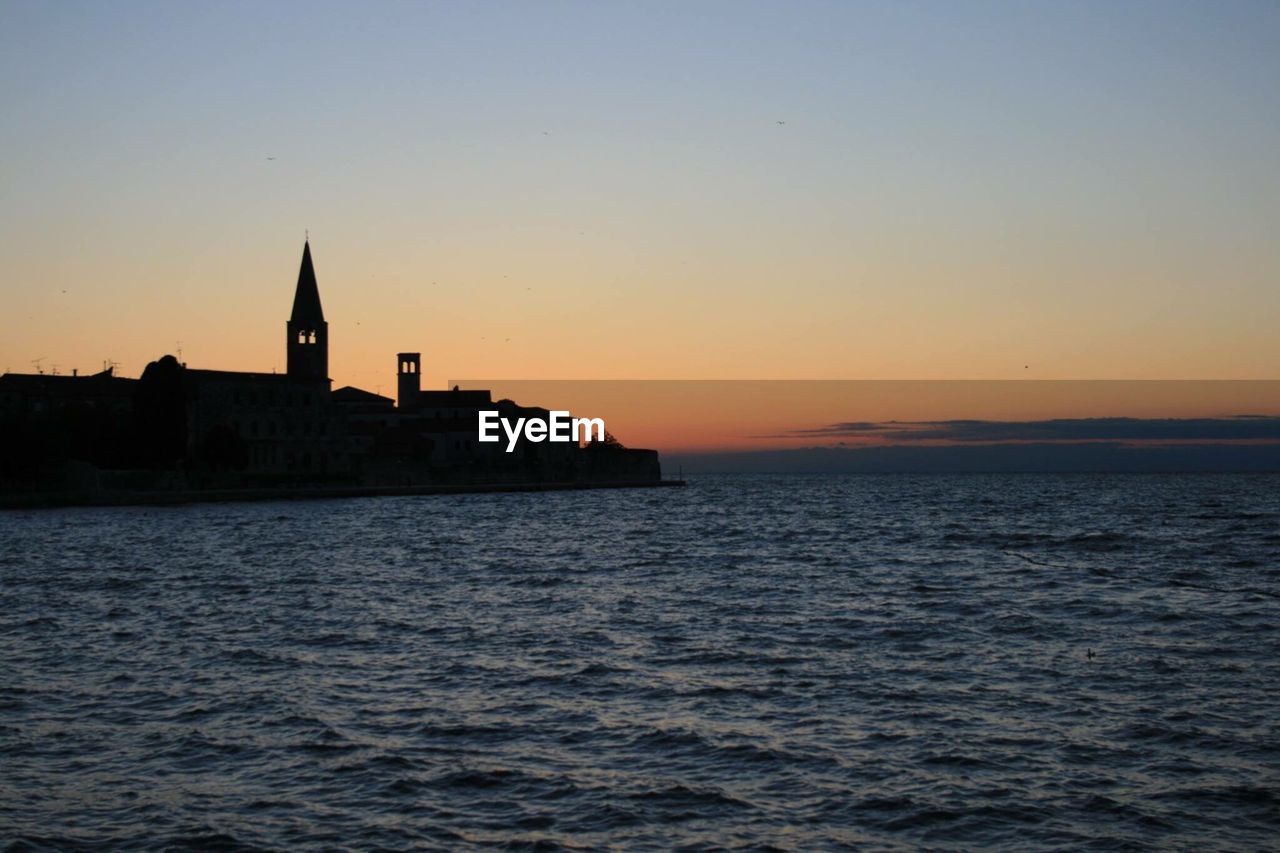 Scenic view of sea against clear sky during sunset