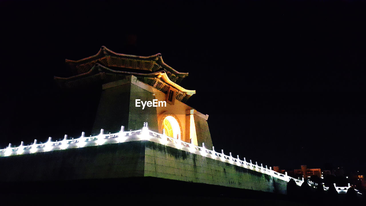 LOW ANGLE VIEW OF ILLUMINATED CATHEDRAL AGAINST SKY AT NIGHT