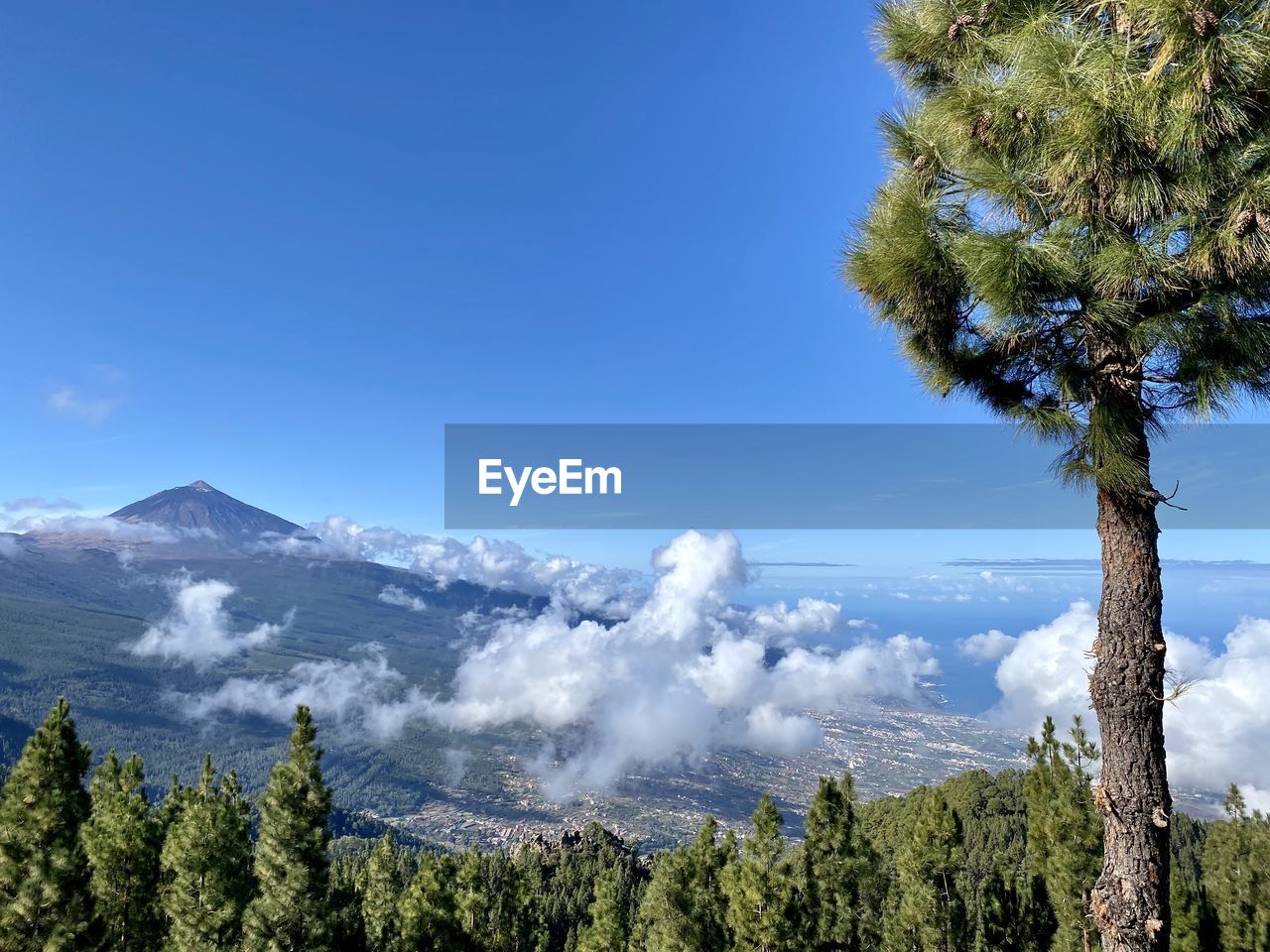 Scenic view of mountains against blue sky