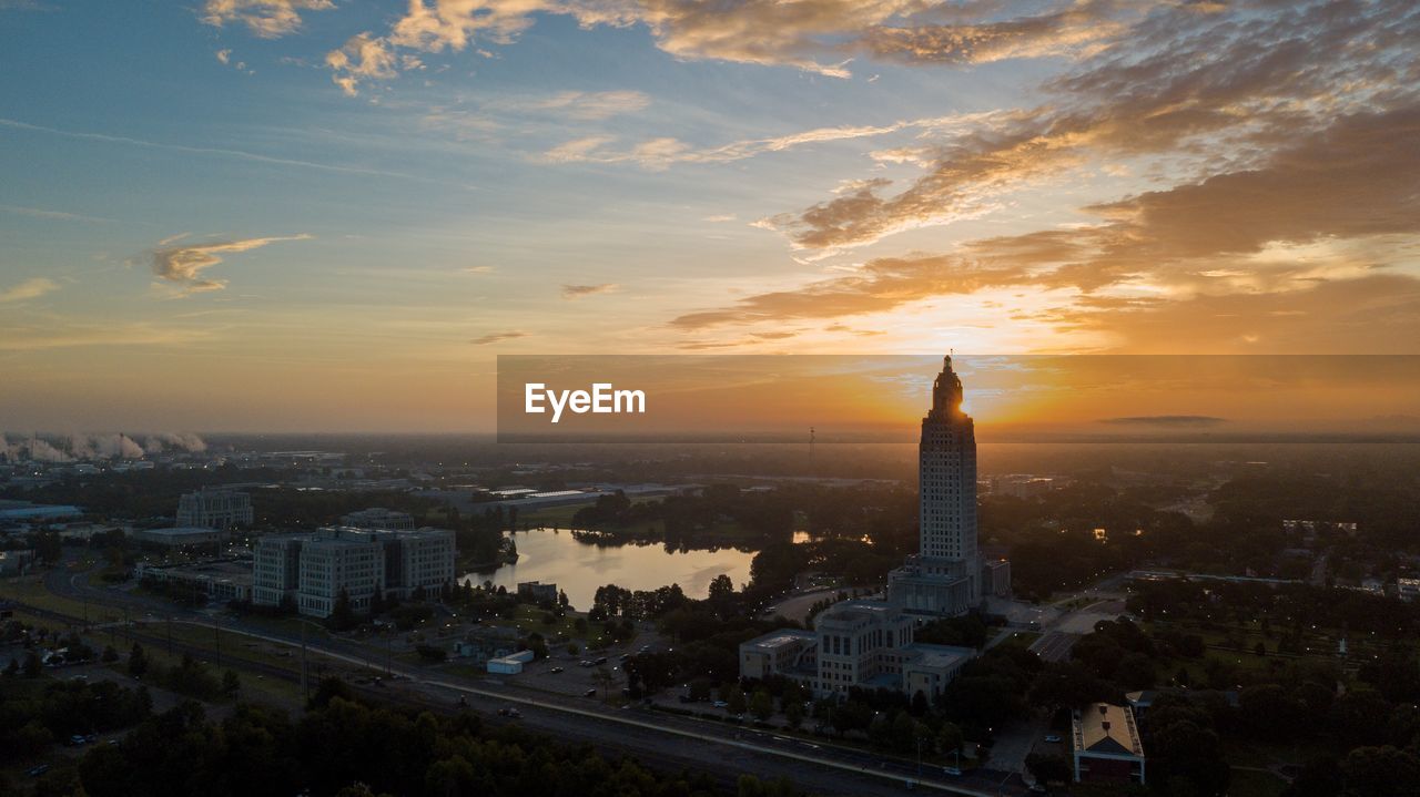 Aerial view of buildings in city during sunset