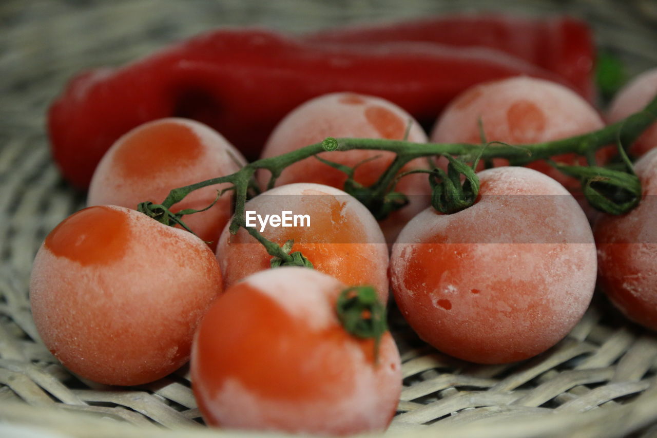 Close-up of frozen tomatoes in wicker basket