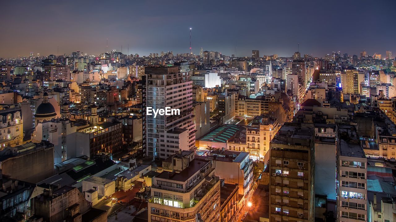 High angle view of city lit up at night