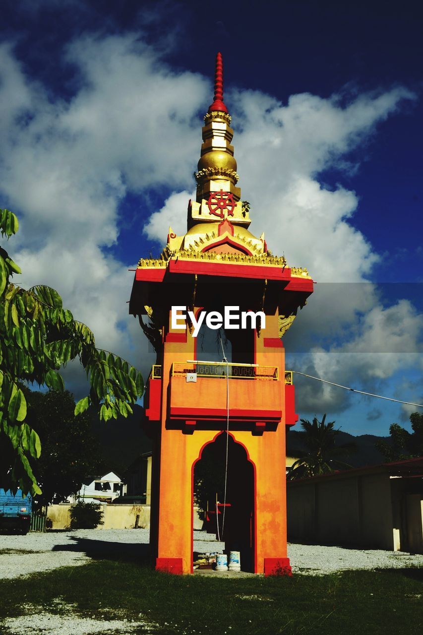 TRADITIONAL BUILDING AGAINST CLOUDY SKY