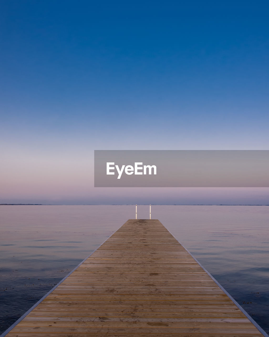 Pier over sea against clear sky