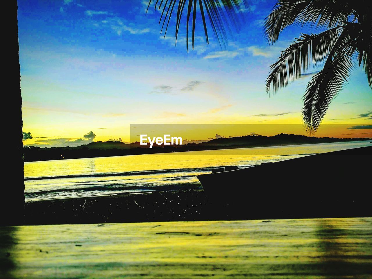 SCENIC VIEW OF BEACH DURING SUNSET