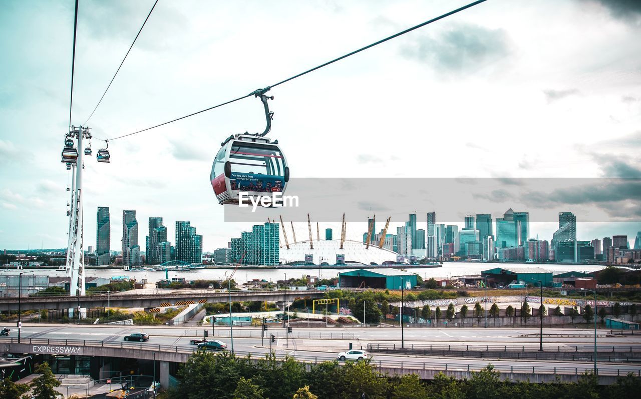 OVERHEAD CABLE CARS OVER BUILDINGS IN CITY