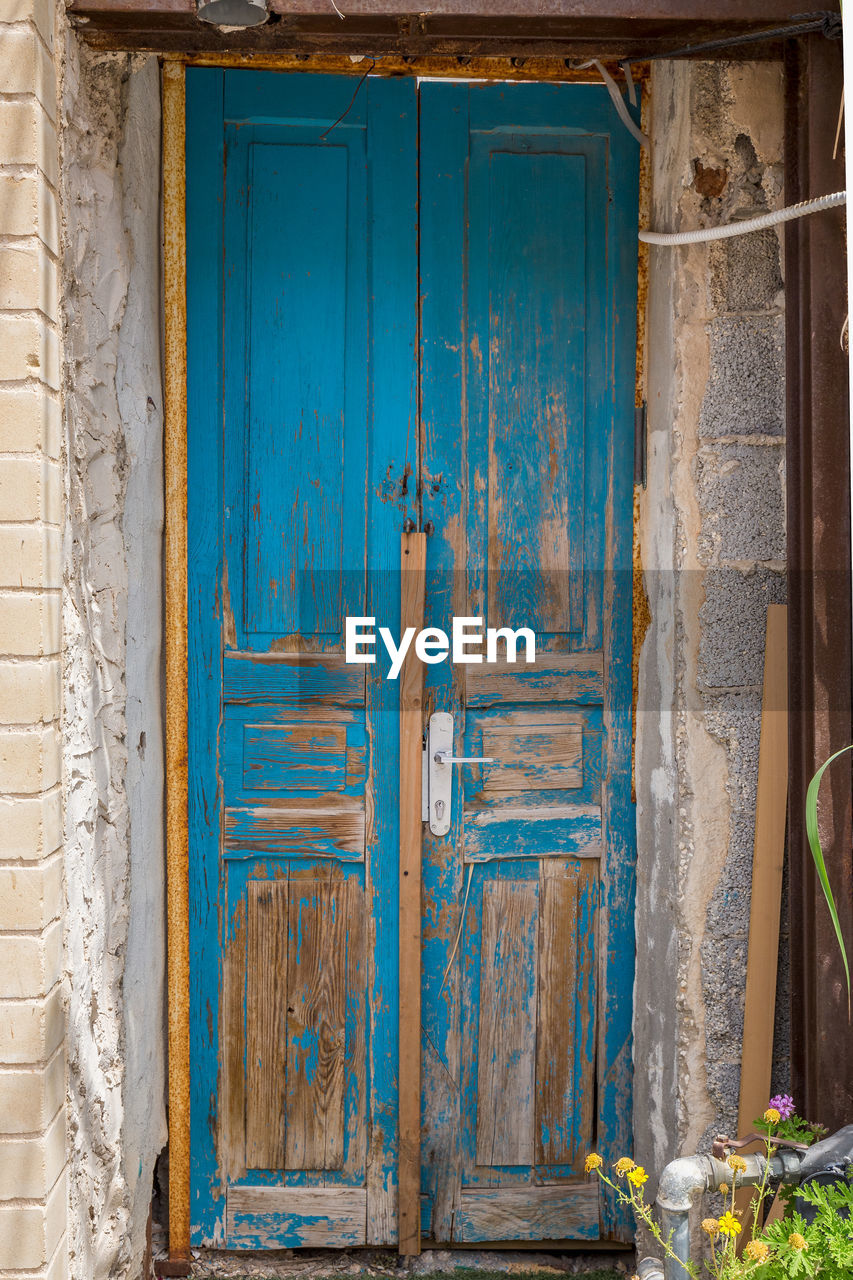 CLOSED DOOR OF OLD HOUSE