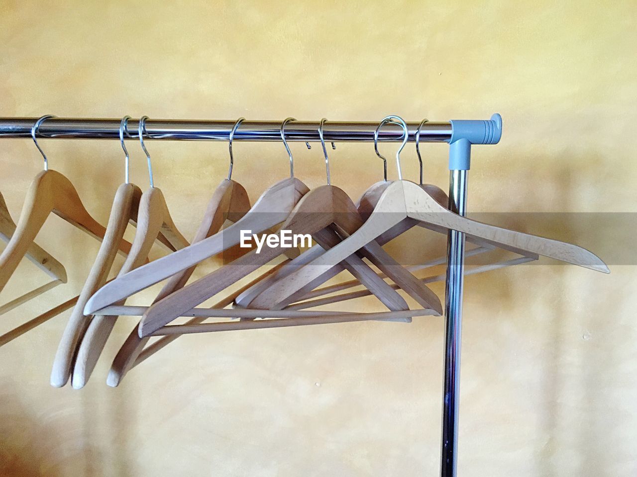 Empty clothes hanger hanging on metal pole