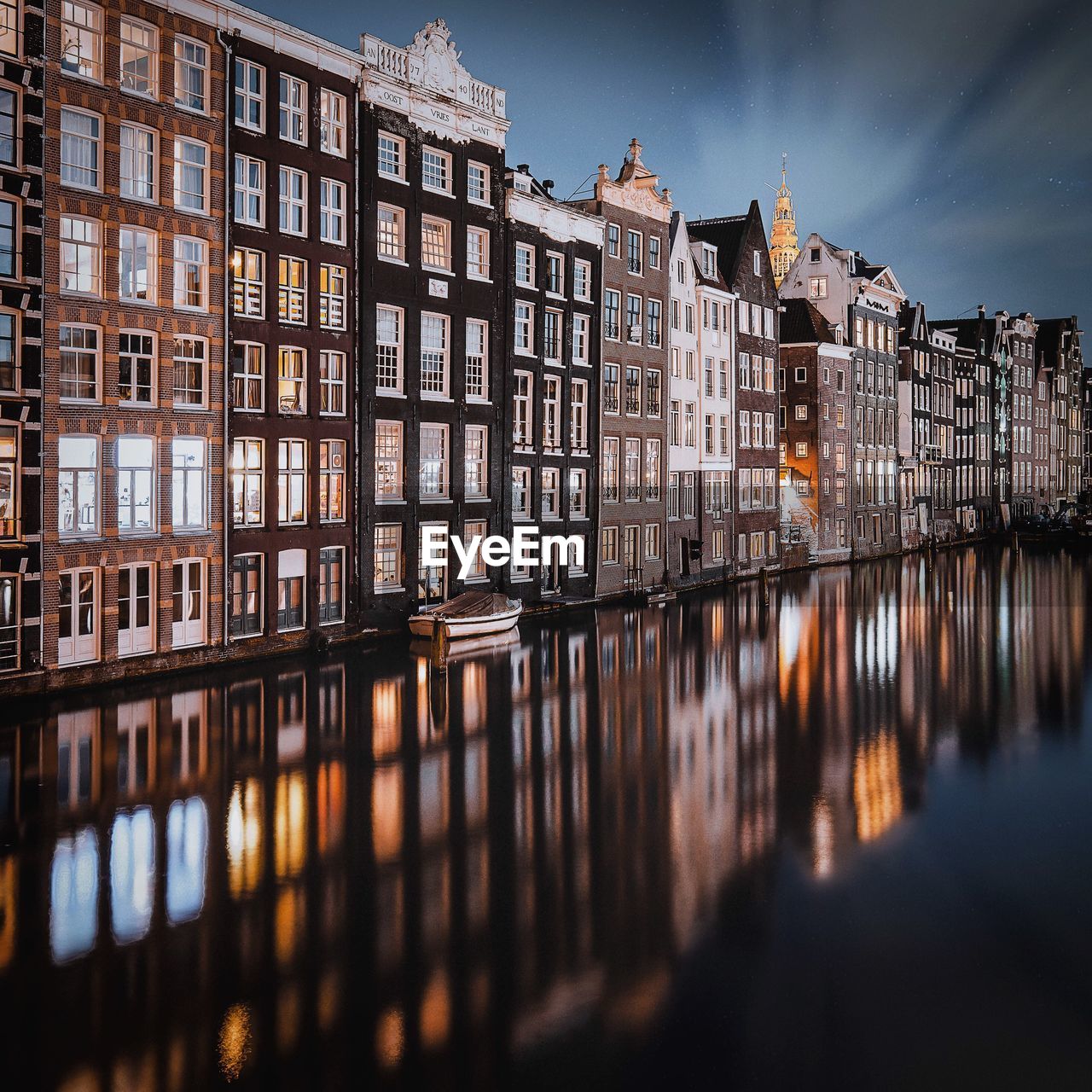 Reflection of building in canal at night