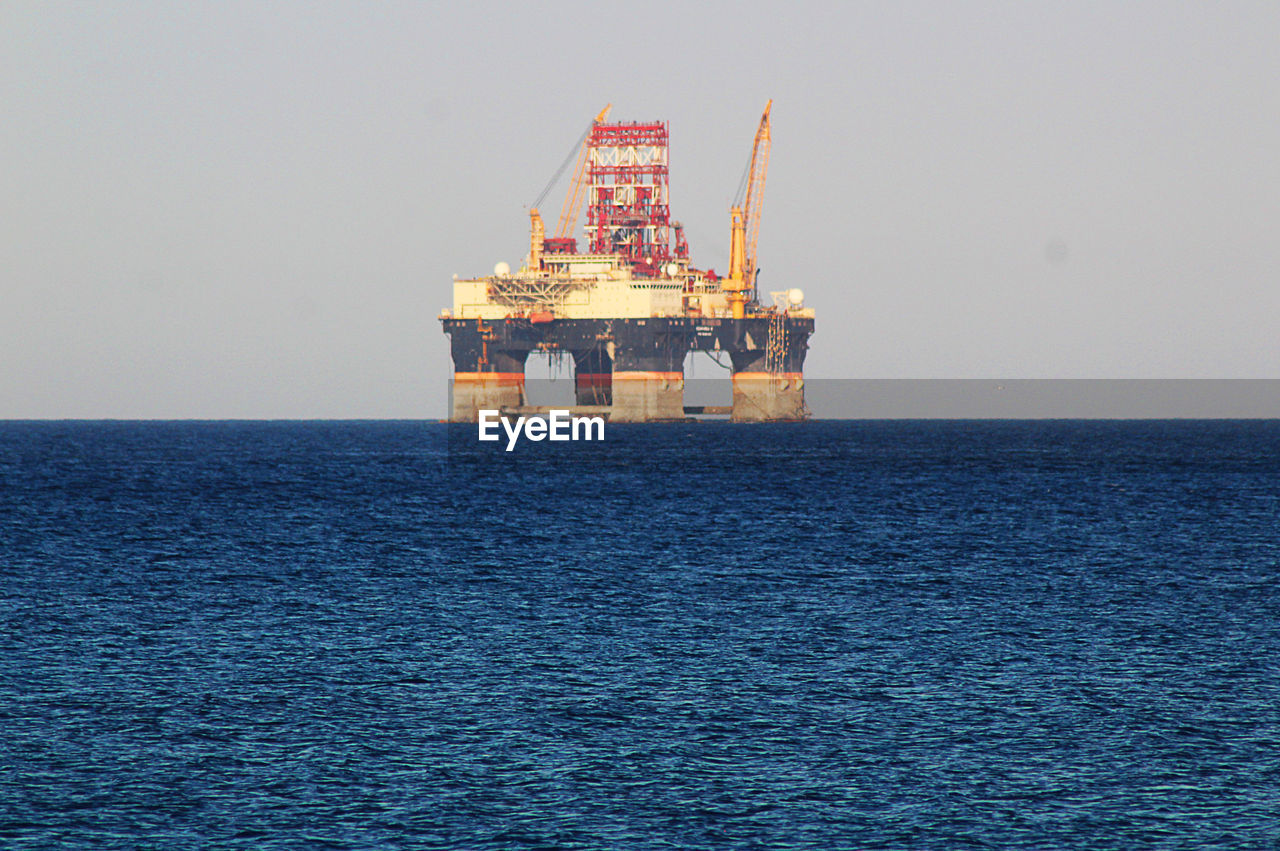 Scenic view of sea against sky. oil gas platform. 