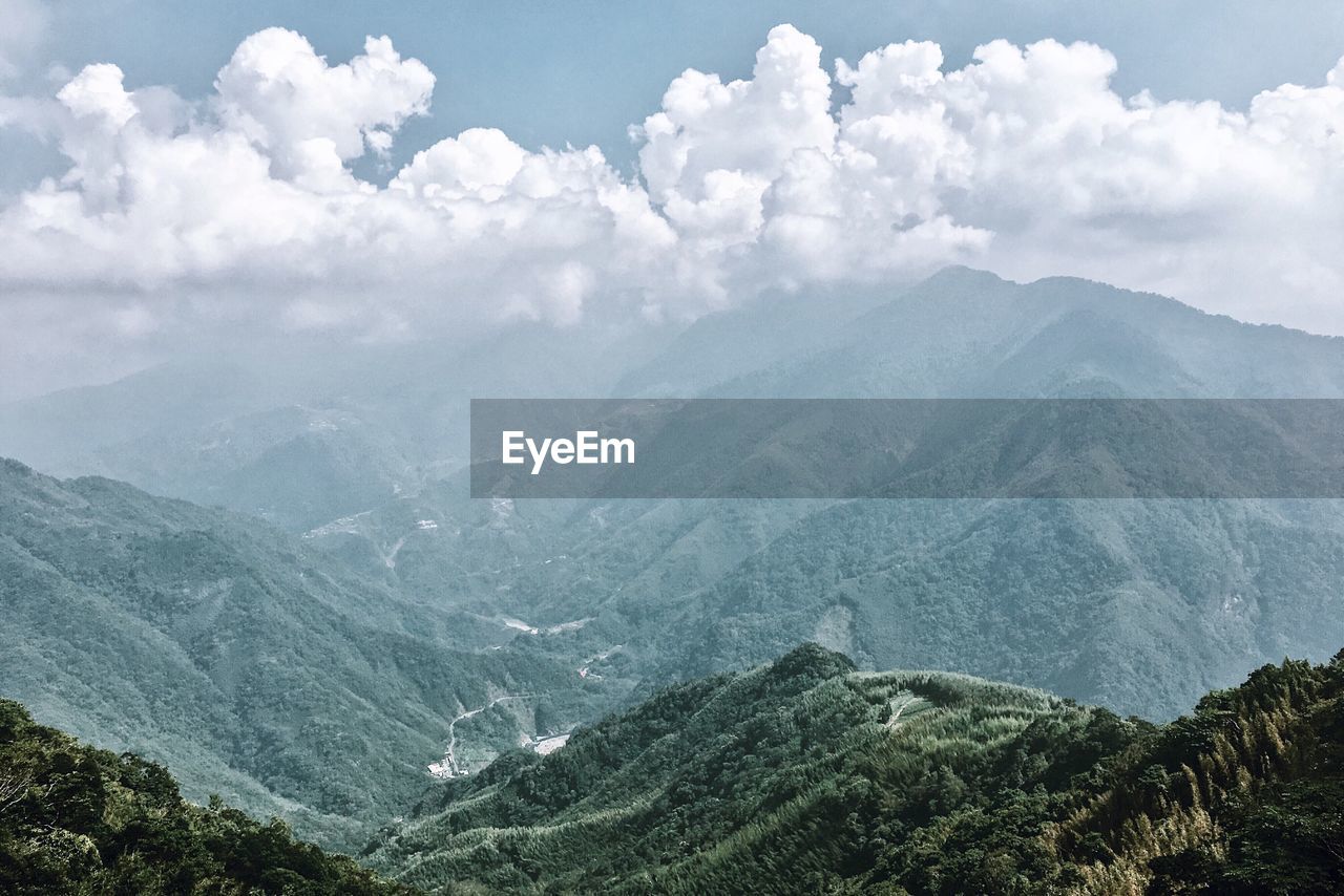 SCENIC VIEW OF TREE MOUNTAINS AGAINST SKY